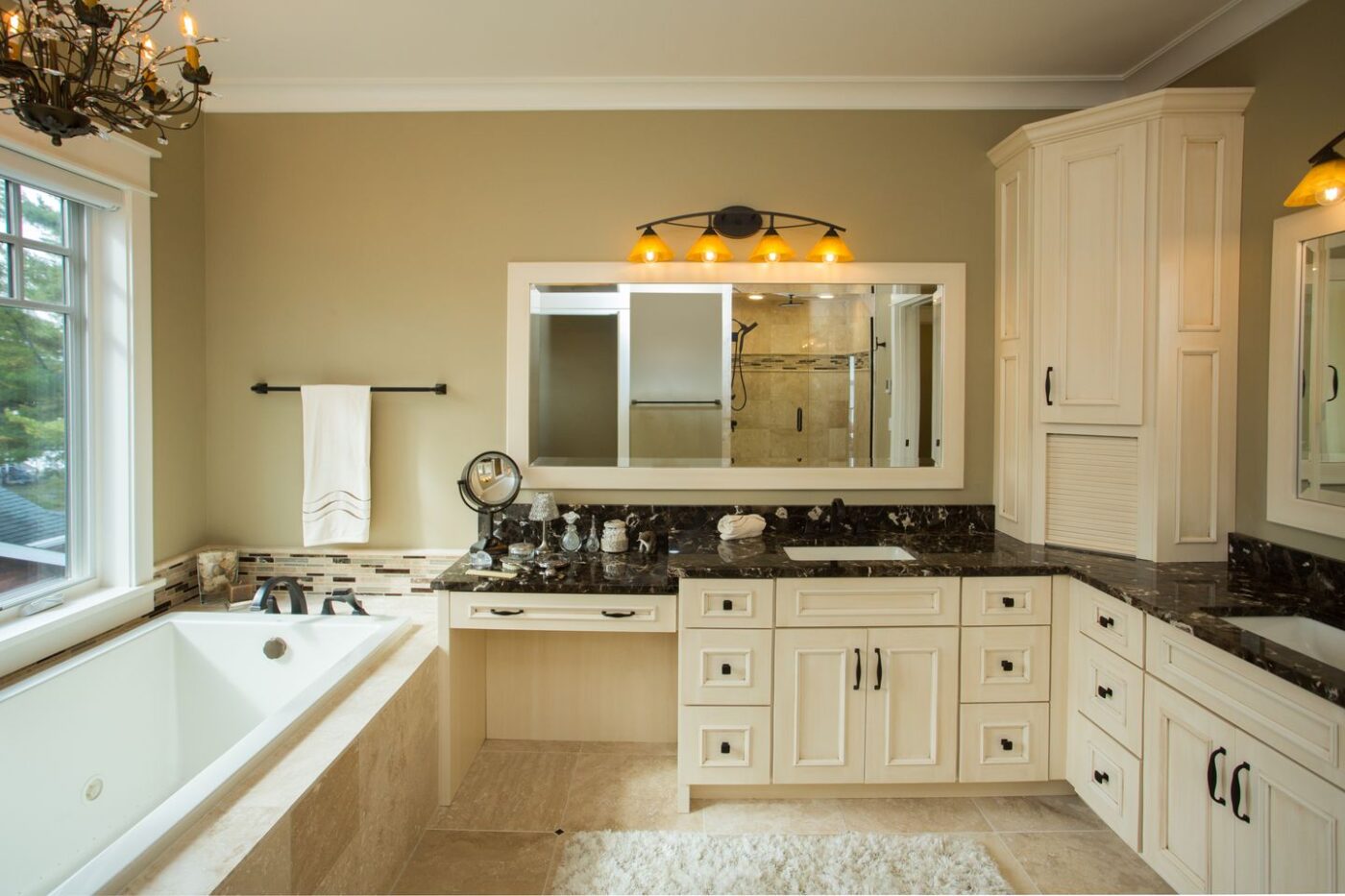 Master bathroom with tub and two sinks