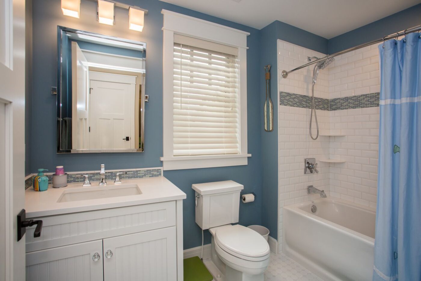Blue bathroom with tiled shower and tub
